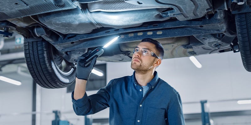 City Toyota in Great Falls MT technician looking under car